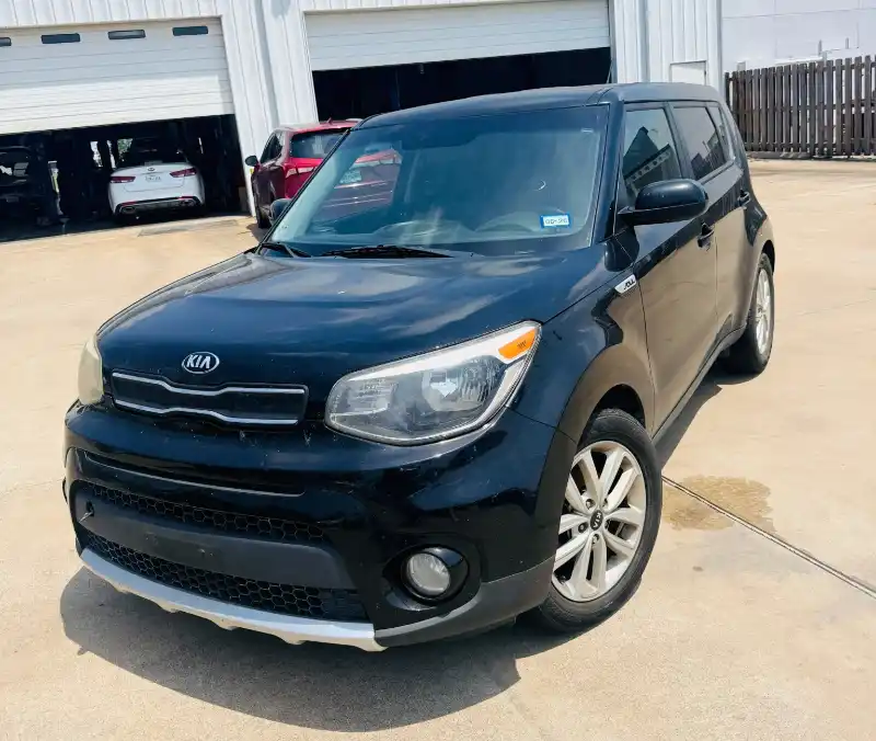 Black Kia Soul parked outside an auto garage after a cash junk car pickup in Spring, TX.