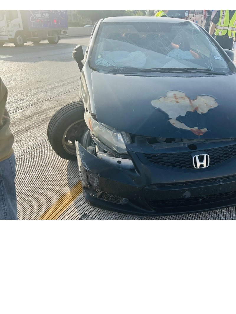 Damaged black Honda Civic sedan after a collision on a roadway in Texas City, TX.